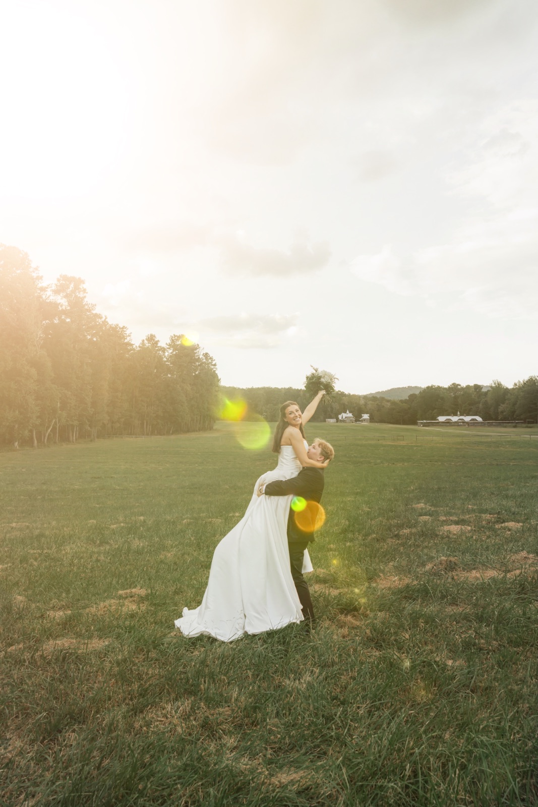 Couple lifted in a golden field at the end of the day